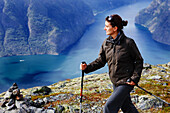 Young woman hiking with a view at the Aurlandsfjord, Prest, Aurland, Sogn og Fjordane, Norway, Scandinavia, Europe