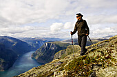 Young woman hiking with a view at the Aurlandsfjord, Prest, Aurland, Sogn og Fjordane, Norway, Scandinavia, Europe