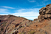 Hiker and observatories under clouded sky, Roque de los Muchachos, Caldera de Taburiente, La Palma, Canary Islands, Spain, Europe