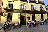 Guests in a pavement cafe, Bar El Hechizado, Calle Huertas, Madrid, Spain