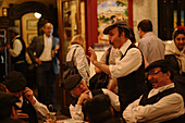 Group of men in a pavement cafe, Fiestas de San Isidro Labrador, Madrid, Spain