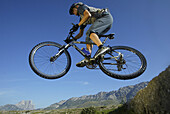 Mountainbiker in mid air, Gran Sasso d'Italia, Abruzzo, Italy