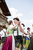 Couples wearing traditional costumes dancing, May Running, Antdorf, Upper Bavaria, Germany
