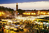 Jemaa el Fna square and Koutoubia mosque minaret in background, Marrakech, Morocco