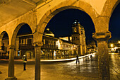 Plaza de Armas with the church of the Society of Jesus in background at night, Cusco, Peru
