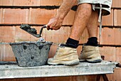 Adult, Boots, Building, Cement, Close up, Feet, Foot, Leg, Legs, Man, Mature, Shoe, Shoes, Spade, Work, Working, A75-981832, agefotostock 