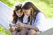 Two girls using their mobile phone