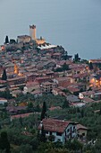 Italy, Veneto, Lake District, Lake Garda, Malcesine, aerial town view and Castello Scaligero castle from Monte Baldo, dusk