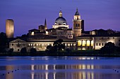 Italy, Lombardy, Mantua, town view and Palazzo Ducale from Lago Inferiore, dusk