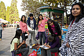 Portrait drawer and foreign students at Green Lake Park, Kunming, Yunnan, People's Republic of China, Asia