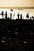 Silhouettes of people at the banks of the river Niger in the evening light, Sagou, Mali, Africa