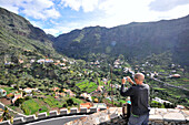 Tourist taking a picture of Valle Gran Rey, Gomera, Canary Isles, Spain, Europe