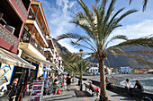 Tourists in cafes on the promenade, Playa de la Calera, Valle Gran Rey, Gomera, Canary Isles, Spain, Europe