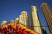 Stall on a fairground and high rise buildings under blue sky, Jumeirah Beach Residence, Dubai, UAE, United Arab Emirates, Middle East, Asia