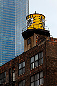 Water tank on a high-rise building, Trump Tower in the background, Chicago, Illinois, USA