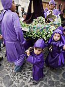 Traditionally dressed men and boys for Easter procession, Antigua, Sacatepequez, Guatemala