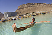 Woman floating in the Dead Sea, En Bokek, Israel, Middle East