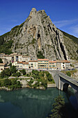 Rock formation above houses and bridge over Durance river, Sisteron, Haute Provence, France, Europe