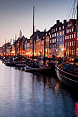 Evening impression at the picturesque historic Nyhavn Canal with pastel painted old town houses, Nyhavn, Copenhagen, Denmark