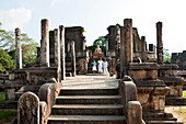 Sinhalese women in the Vatadage on the terrace of the tooth relic, Polonnaruwa, Sri Lanka, Asia