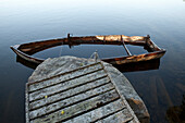 Half sunken wooden rowing boat at a jetty, island of Norrbyskaer, Vaesterbotten, Sweden, Europe
