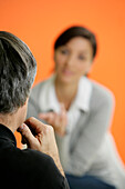 Young woman in conversation with a man