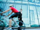 Businessman, cyclist passing