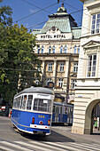 Tram in front of Hotel Royal on Stradomska Street, Krakow, Poland, Europe
