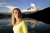 Young woman near lake Lautersee, Mittenwald, Werdenfelser Land, Upper Bavaria, Germany
