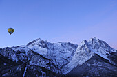 Hot-air balloon flying towards Alpspitze, Zugspitze and Waxensteine, aerial view, Garmisch-Partenkirchen, Wetterstein range, Bavarian alps, Upper Bavaria, Bavaria, Germany, Europe