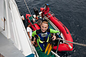 Diver enters Liveabord after Diving, Raja Ampat, West Papua, Indonesia