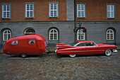 American car with red caravan