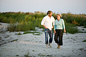 Man and woman walks on the beach