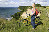 Woman with bike on Backafall, Ven, Skåne, Sweden