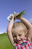 Girl has picked a bouquet of daisies and cornflower