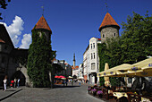 Stadtmauer mit Türmen am Eingang zur Einkaufstrasse Viru und Rathausturm, Tallinn, Estland, Europa