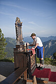 Man decorated an altar, Schachen, Wetterstein range, Upper Bavaria, Germany