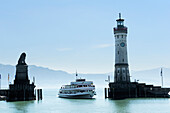 Ship arriving at the harbour, lighthouse, Lindau, lake Constance, Bavaria, Germany
