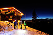 Three men backcountry skiing at night reaching hut Staufner Haus, Hochgrat, Nagelfluh range, Allgaeuer Alpen range, Allgaeu, Bavaria, Germany