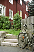 Bike in front of a red wooden house, Eksjö, Smaland, Sweden, Europe