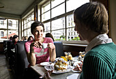 Two women having breakfast in a cafe, Leipzig, Saxony, Germany