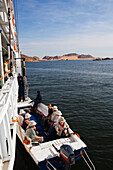 Passengers of cruise ship Prince Abbas in a motor boat, Lake Nasser, Egypt, Africa