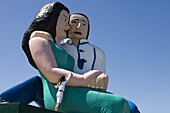Mädchen klettert auf eine überdimensionale Skulptur eines Paares, Puerto Montt, Los Lagos, Patagonien, Chile, Südamerika, Amerika