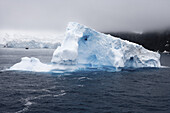 Antarctic iceberg and expedition cruiseship National Geographic Explorer, South Shetland Islands, Antarctica