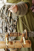 Reenactor, female pioneer, spinning wool. Confederate Memorial Park. Marbury. Alabama. USA.