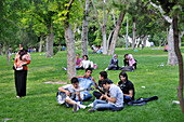 young people play guitars the park at Tepesi, Citadel, Konya, Anatolia, Turkey