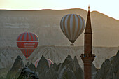 ballooning near minaret in the valley of Göreme, Cappadocia, Anatolia, Turkey