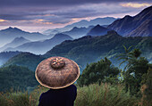 Rice farmer looking at morning mist in the Cordilleras Mountains, Mountain Province, Philippines, Asia
