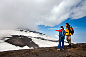 Two hikers at Mount Etna, Sicily, Italy