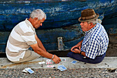 Men playing cards at the port of Camara de Lobos, Madeira, Portugal